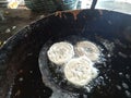 Jalebi sweets are being made in a pan.